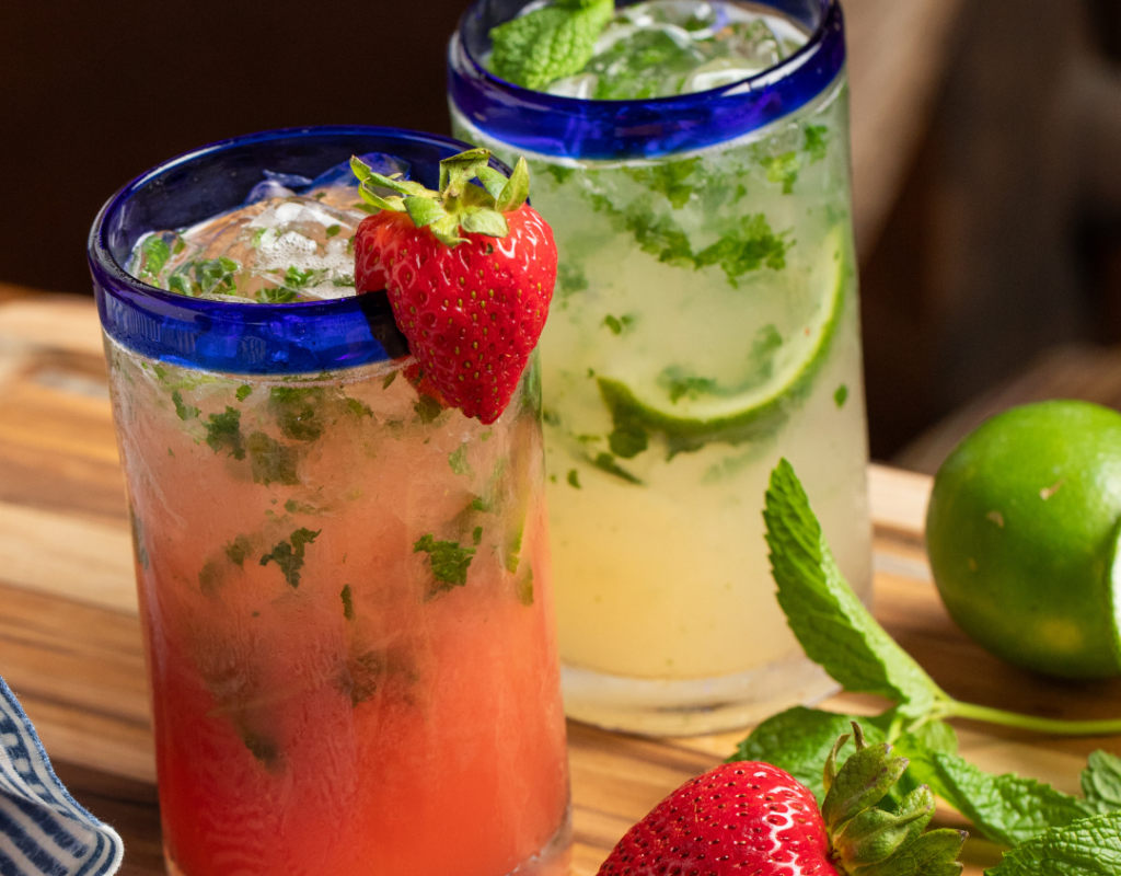 Wooden counter with strawberry mojito and cucumber and jalapeno mojito