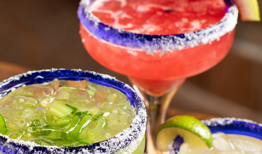 Close up of jalapeno margarita and watermelon margarita with salted rim